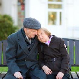 Retirement: an elderly couple sits on a bench in the park