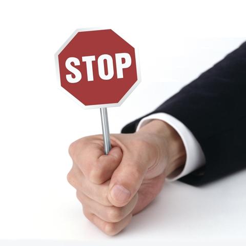 Cloned firms: a man holds a stop sign in his hand
