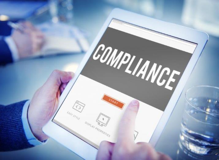 Compliance: a man starts to fill in a compliance questionnaire on a tablet