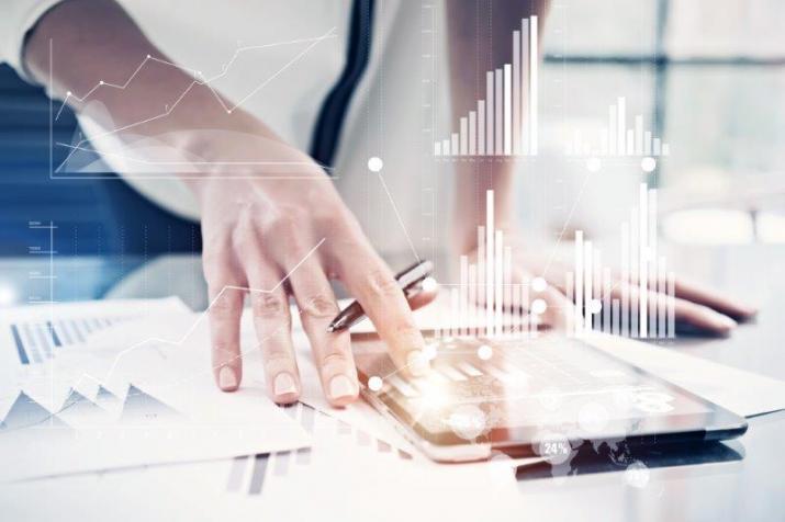 Statutory auditor: a man studies graphs on his tablet in a working environment